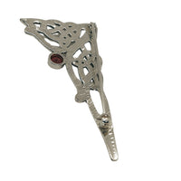 view of the back of the brooch, with a red stone and a safety catch