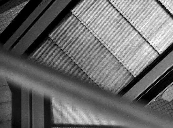Detail of step texture in black and white Escher inspired picture of escalators in Victoria Square Belfast